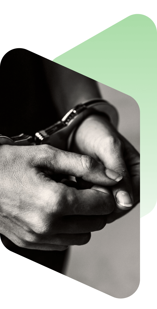 Close-up of hands in handcuffs, symbolizing legal or criminal justice context